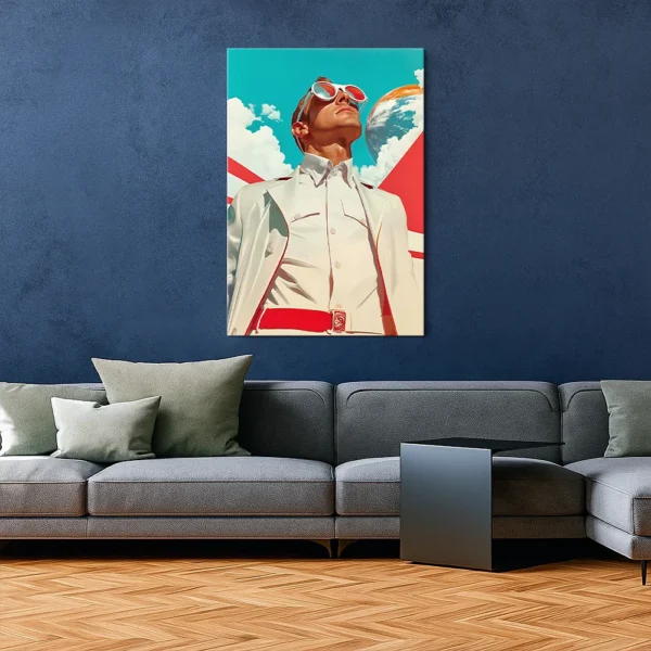 Retro-futuristic art poster hanging in a minimalist interior with a blue wall and modern gray sofa